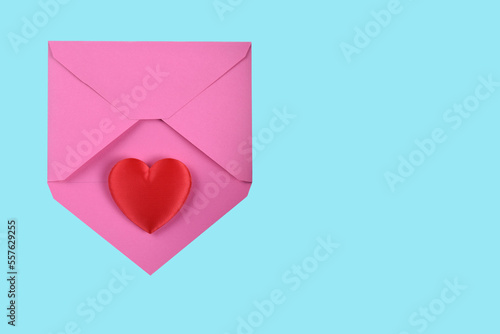 Valentines Day Concept. Red Heart on a pink envelope, with teal background and copy space.
