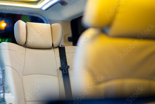 The seats in the car are made of beige brown leather, elegant, with seat belts on days when resting during long trips and travel