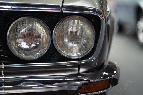 Close-up of the headlights of a vintage car, retro vintage car under the lights