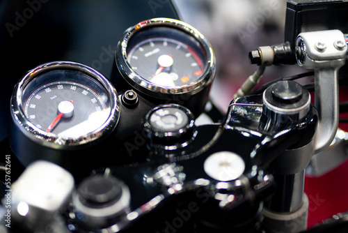 Horizontal close-up of the speedometer and tachometer of a vintage motorcycle