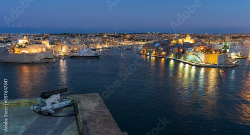 Valletta, Malta waterfront at night with a cannon from the Saluting Battery in foreground