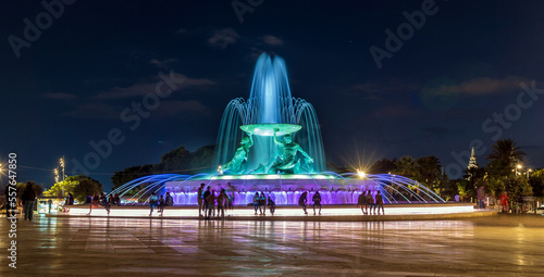 Triton Fountain in Valletta Malta at night with people in silhouette