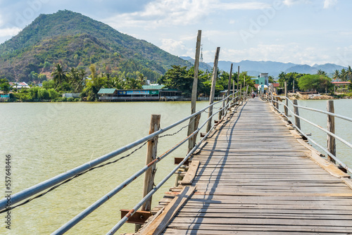 Fototapeta Naklejka Na Ścianę i Meble -  A rustic wooden plank bridge over a river at Nha Trang in Vietnam