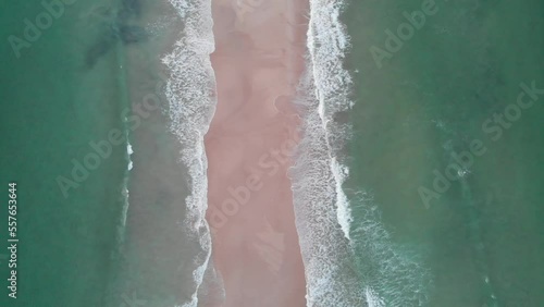 Drone video of the Fingal spit at sunrise, with waves crashing on both sides of the sand bar.