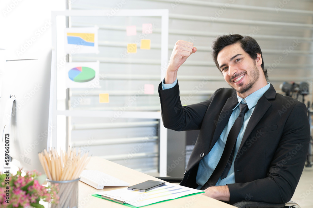 Portrait of businessman pushing his hand up to cheer up, business success concept