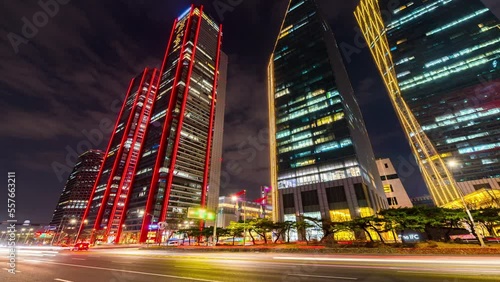 Business and finance concept, moody time lapse view looking up at modern office building architecture in the Yeouido, financial district, at nigth in Seoul City. South Korea.