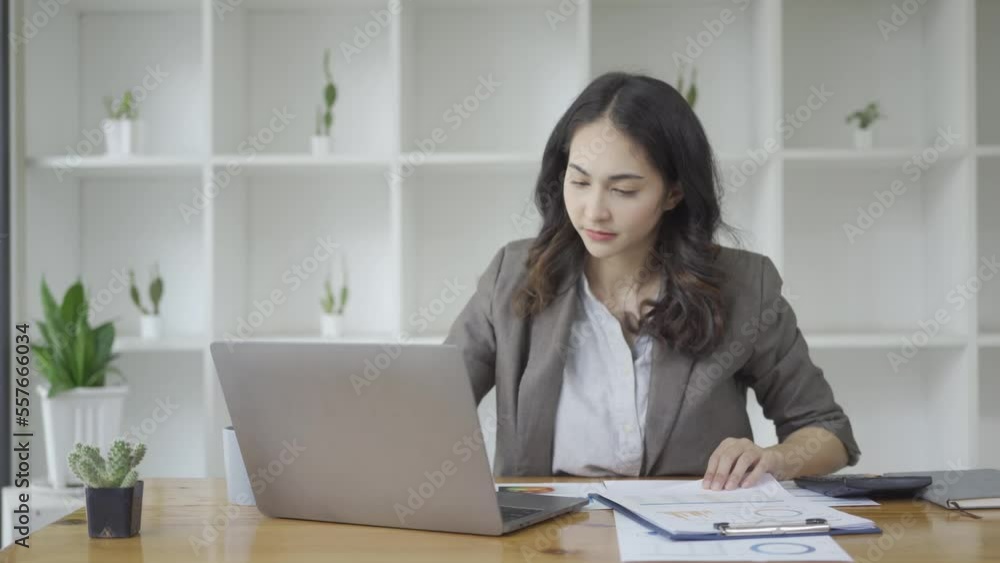 Businesswoman looking at paper, charts, graphs and calculating financial expenses with statistics and calculator, girl working at office, financial analysis while working on laptop Businesswoman looking at paper, charts, graphs and calculating financial expenses with statistics and calculator, girl working at office, financial analysis while working on laptop