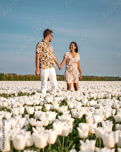 A couple of men and women in a tulip field during Spring in the Netherlands photo