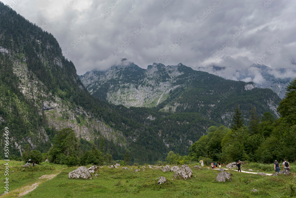 Tourists trekking the route between Königssee and Obersee lakes, in the extreme southeast Berchtesgadener Land district of the German state of Bavaria, near the Austrian border