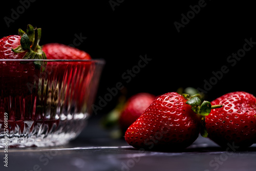 Fresh Organic Strawberries on a dark granite surface photo