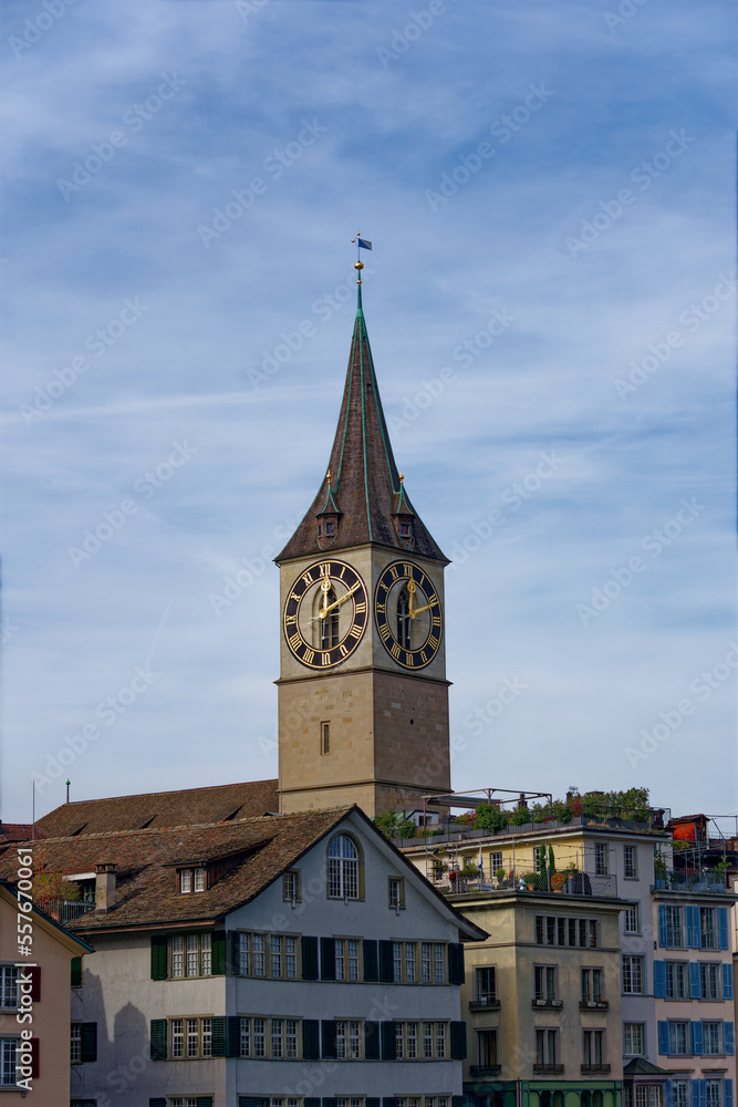 Church tower of famous church St. Peter at the medieval old town of Zürich on a blue cloudy autumn day. Photo taken October 30th, 2022, Zurich, Switzerland.