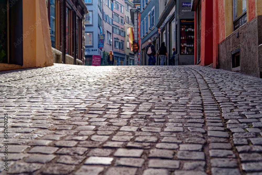 Fototapeta premium Niederdorf alley at the old town of Zürich with colorful medieval house facades on a blue cloudy autumn day. Photo taken October 30th, 2022, Zurich, Switzerland.