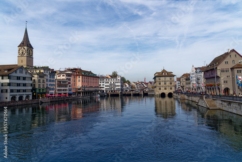 Scenic view over the old town of City of Zürich with Limmat River in the foreground on a blue cloudy autumn day. Photo taken October 30th, 2022, Zurich, Switzerland.