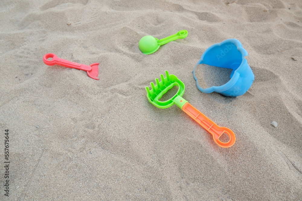 Plastic beach toys on the sand of a beach Plastic beach toys on the sand of a beach