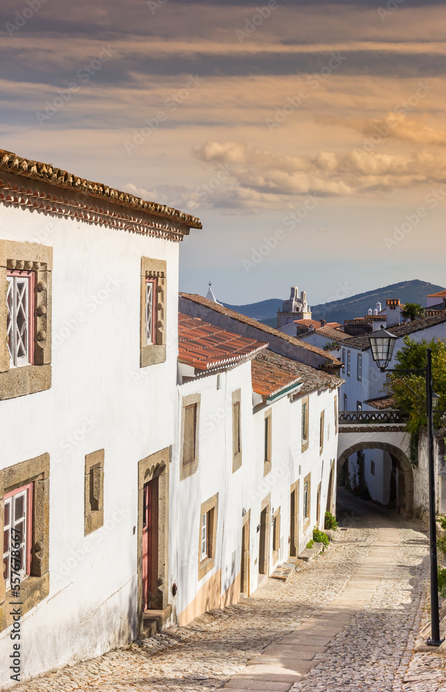 Sunset over a cobblestoned street in the historic center of Marvao, Portugal