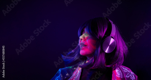 Woman in headphones listening music and enjoing