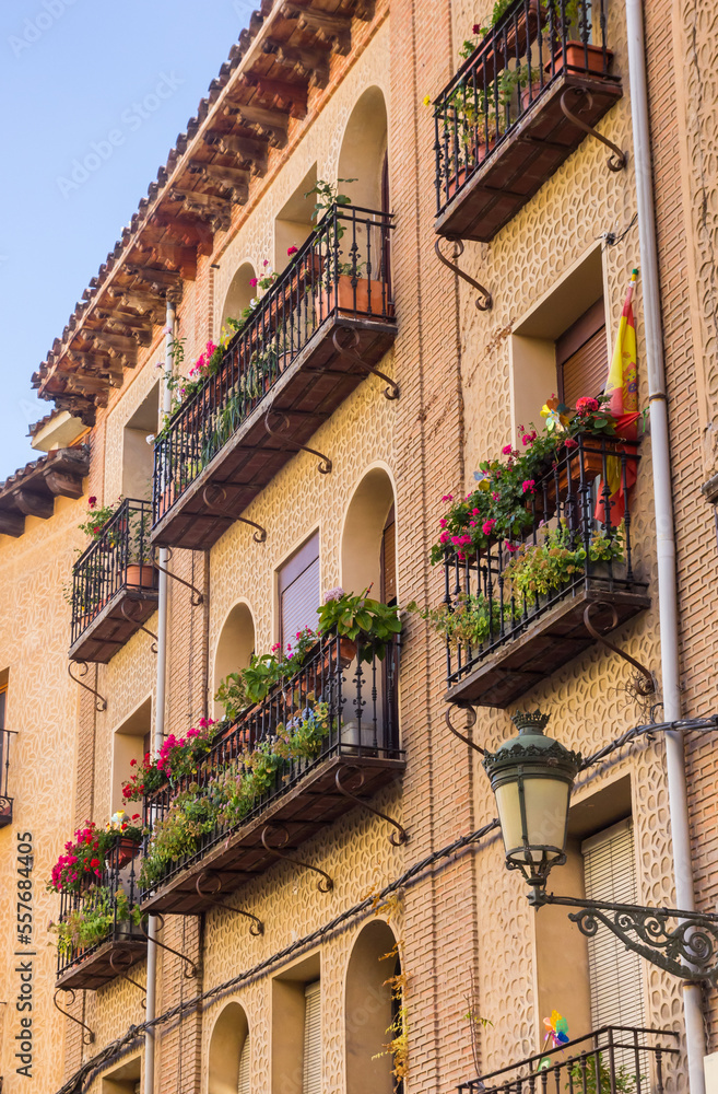 Balconies with colorful flowers on houses in Segovia, Spain