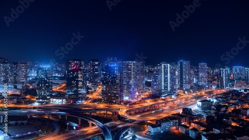 Wallpaper Mural 4K UHD timelapse of car traffic and people crossing road at night in Istanbul city downtown. Drone aerial top view, fly upward. Commuter, Europe city life or public transportation concept stock video. Torontodigital.ca
