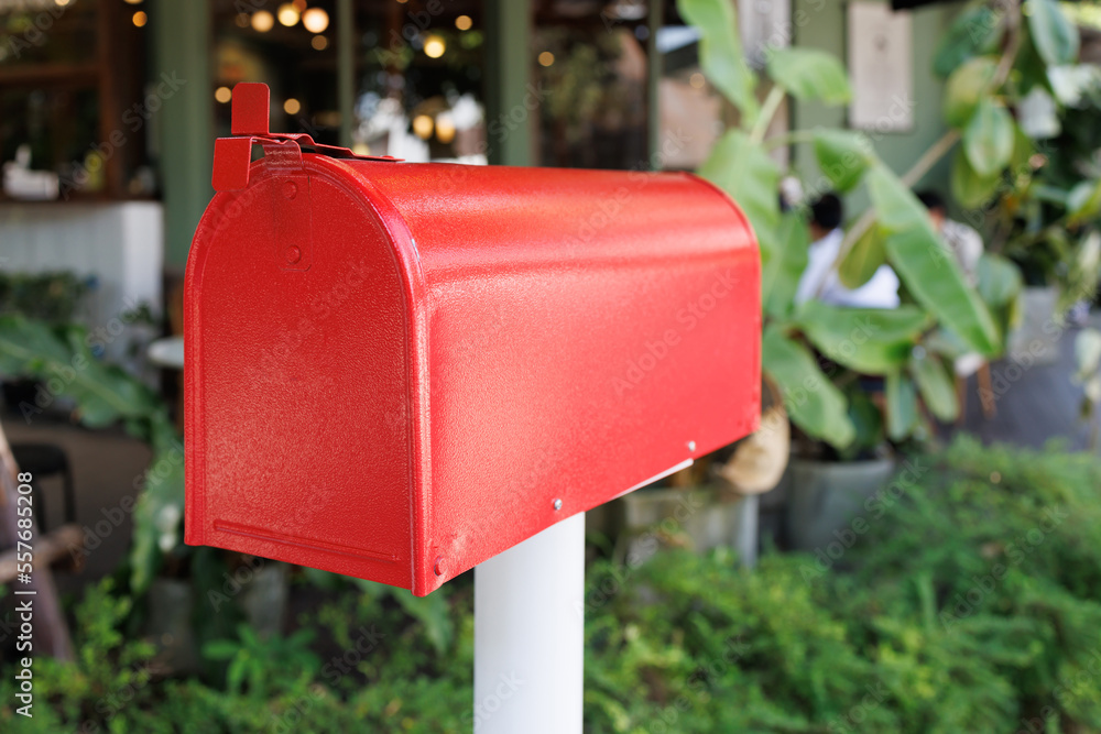 Red Mailbox with house background. red metal newspaper box with shop background. Red Mailbox with house background. red metal newspaper box with shop background.