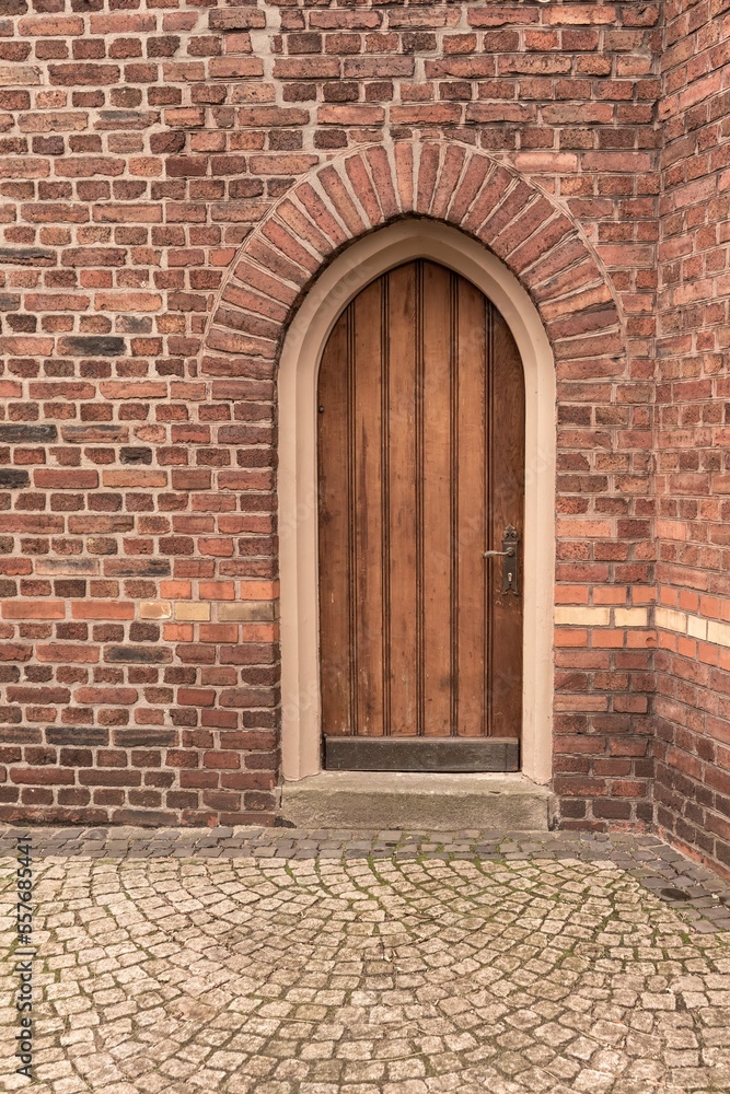 old wooden door in a brick wall old wooden door in a brick wall