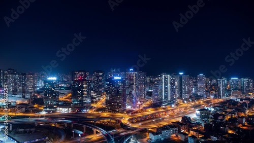 4K UHD timelapse of car traffic and people crossing road at night in Istanbul city downtown. Drone aerial top view, fly upward. Commuter, Europe city life or public transportation concept stock video.