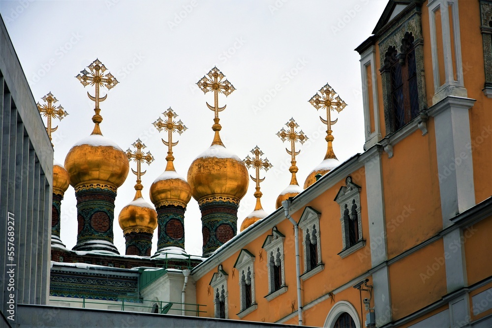 Moscow Kremlin architecture, popular landmark. Terem churches golden onions covered by the snow.