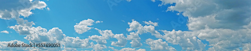 Blue sky with fluffy clouds wide background