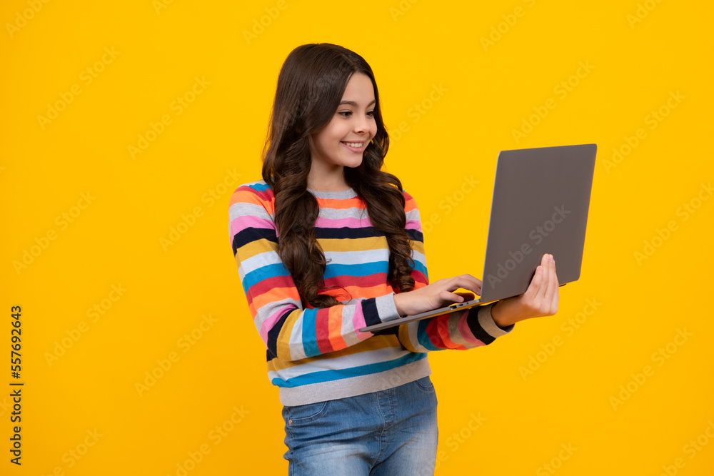 Excited face. Smart little boy with laptop in casual clothes isolated over yellow background. Happy teenager, positive and smiling emotions of teen school girl. Excited face. Smart little boy with laptop in casual clothes isolated over yellow background. Happy teenager, positive and smiling emotions of teen school girl.