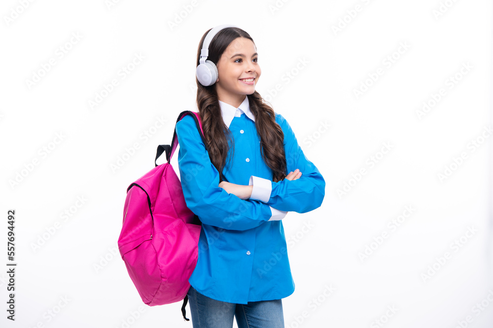 Schoolgirl, teenage student girl in headphones on white isolated studio background. School and music education concept. Back to school. Schoolgirl, teenage student girl in headphones on white isolated studio background. School and music education concept. Back to school.
