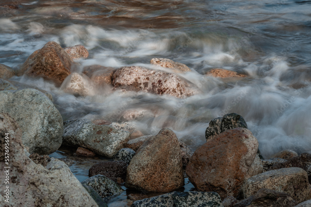 Long exposure close-up 121mm shot of ocean waves hitting the rocks Long exposure close-up 121mm shot of ocean waves hitting the rocks