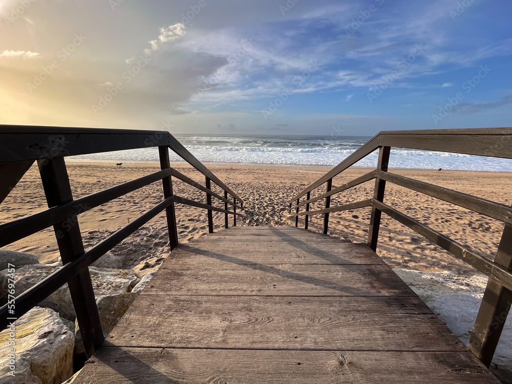 A wooden boardwalk leads to the beach 