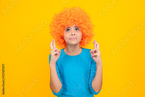 Girl with yellow wig. Funny child wearing orange curly wig hair  summer fun.