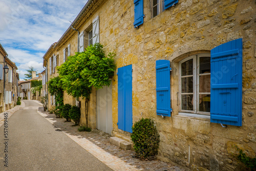 Wallpaper Mural Quaint and flowery facades of townhouses with colorful wooden shutters and doors in the village of Terraube in the South of France (Gers) Torontodigital.ca