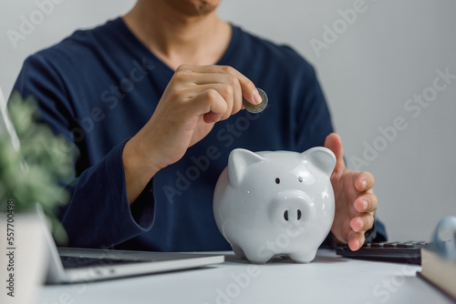 Man saving money in a piggybank. Business saving and money financial investment concept.