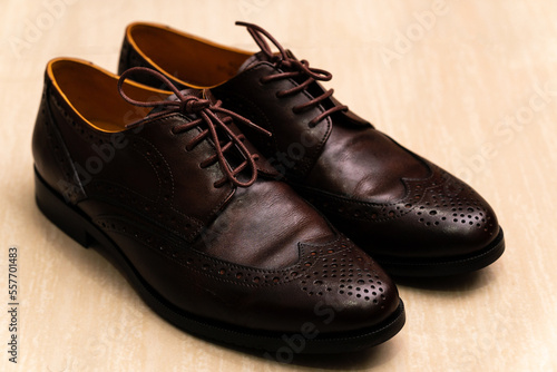 Brown brushed leather shoe with broguing