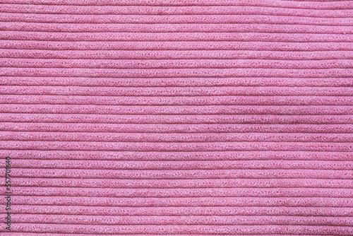Closeup of pink corduroy cloth as patterned textured background photo