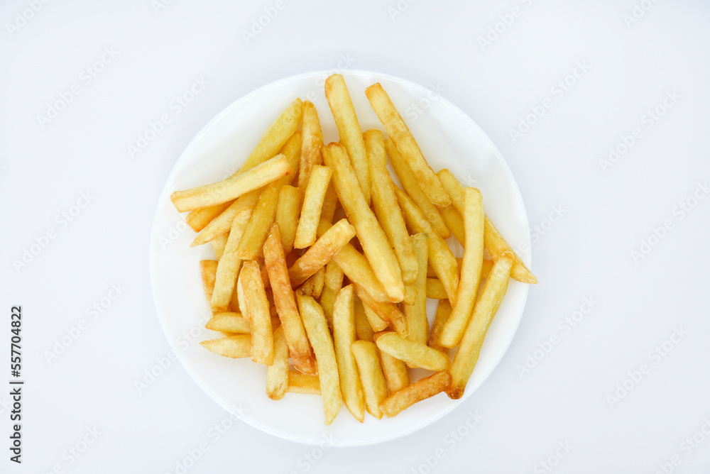 Yellow delicious French fries in white dishes. Fast food on a plate. Fried potatoes. Toasted potato slices on a white background.