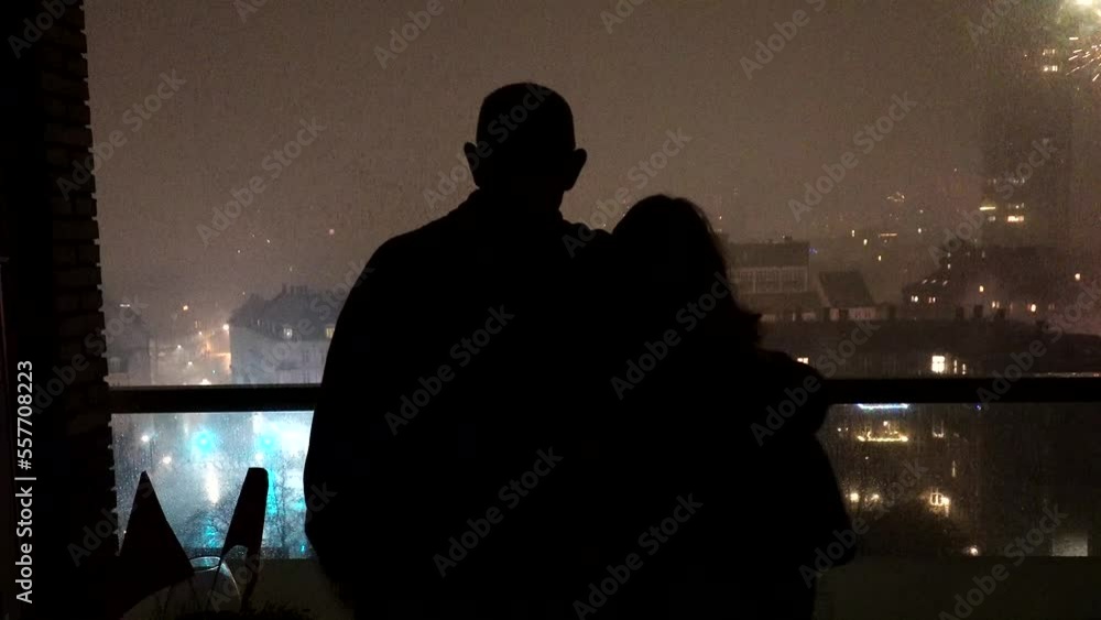 Copenhagen, Denmark A couple watch fireworks from an apartment window at New Year's. Copenhagen, Denmark A couple watch fireworks from an apartment window at New Year's.