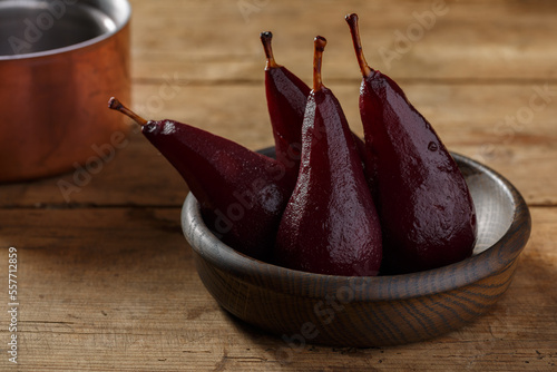 Delicious mulled wine poached pears served on the old table