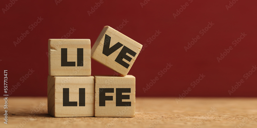 live life. Closeup of word on plastic cube on wooden desk background concept live life. Closeup of word on plastic cube on wooden desk background concept