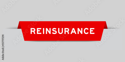 Red color inserted label with word reinsurance on gray background