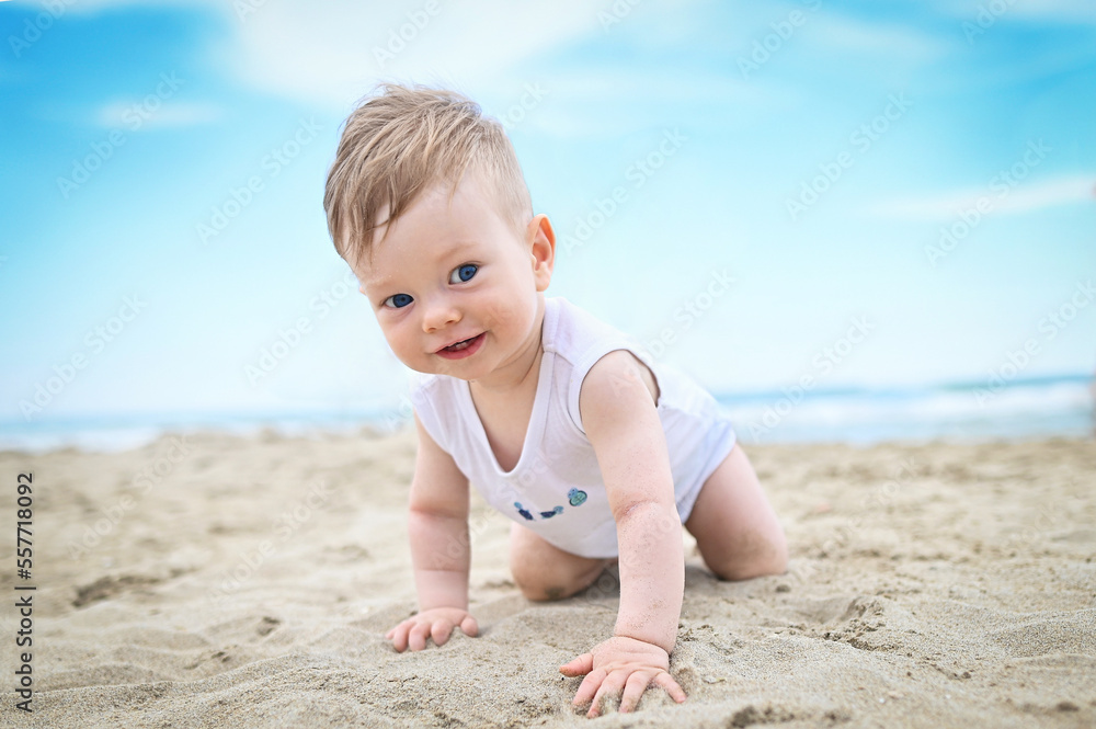 Happy child playing with sand at the beach. Happy little toddler boy portrait Happy child playing with sand at the beach. Happy little toddler boy portrait