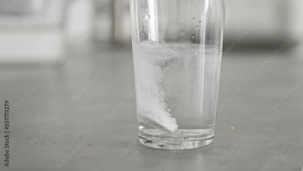 Fizzy pill in glass of water Fizzy pill in glass of water
