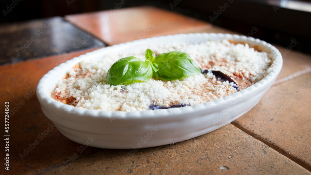 Parmigiana. It's like a lasagna made of aubergines, with grated cheese, tomato sauce and basil leaves. Parmigiana. It's like a lasagna made of aubergines, with grated cheese, tomato sauce and basil leaves.