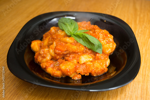 Gnocchi with bolognese sauce and tomato. Traditional Italian recipe.