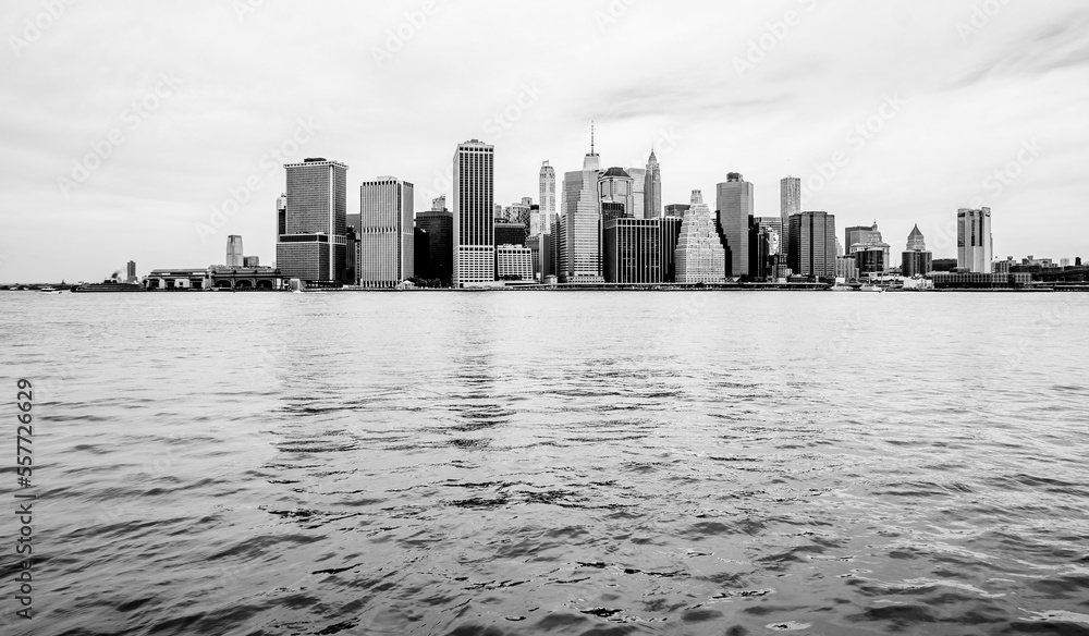 Black and white photo of downtown Manhattan over East River and Brooklyn, USA