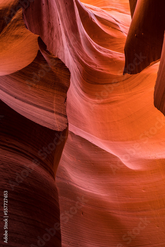 Orange and red curving narrow walls of stone and sand in Antelope Canyon, USA