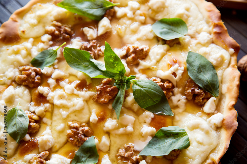 Sweet pizza with fresh cheese, nuts and honey. Neapolitan pizza made with Italian Recipe. Sweet pizza with fresh cheese, nuts and honey. Neapolitan pizza made with Italian Recipe.