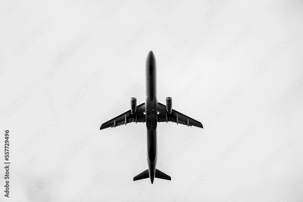 Black and white photo of airplane view from down below at RIX (Riga Airport)