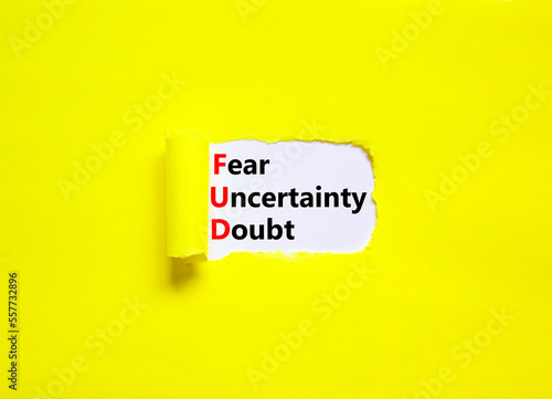 FUD fear uncertainty doubt symbol. Concept words FUD fear uncertainty doubt on white paper on a beautiful yellow background. Business and FUD fear uncertainty doubt concept. Copy space. photo